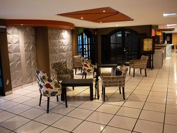Representative hotel space: A hotel lobby seating area with patterned chairs around a table.