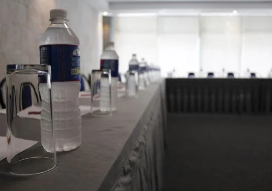 Representative hotel space: A dining table is set with drinking glasses and water bottles.
