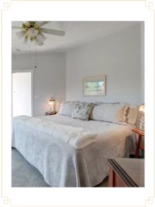 Representative hotel space: A bedroom with a bed beneath a framed picture.
