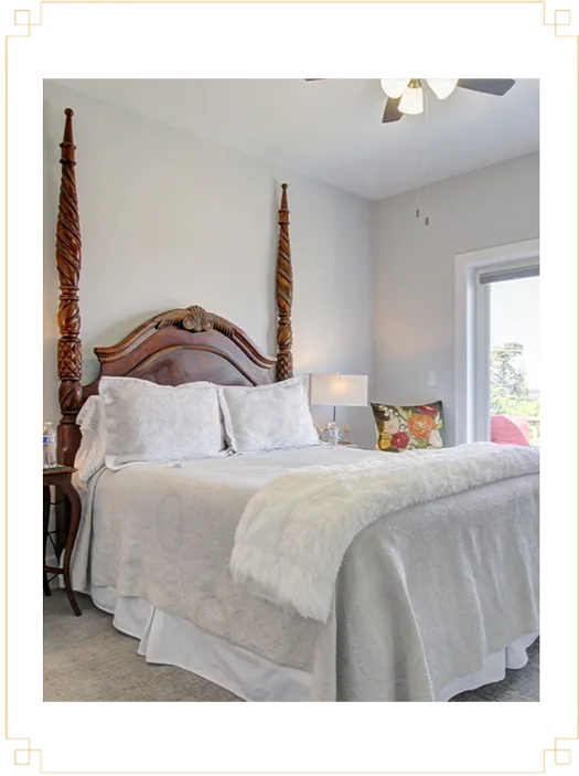 Representative hotel space: A bedroom with a large bed, white bedding, and a window.