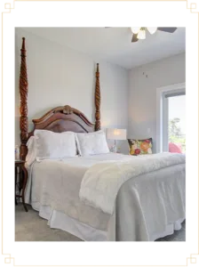Representative hotel space: A bedroom with a bed, white bedding, and a window.