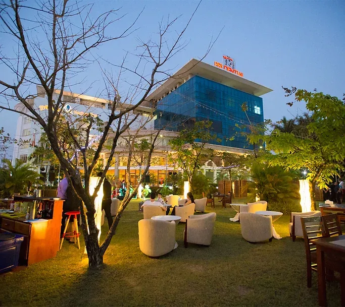 Representative hotel space: A hotel exterior with an outdoor seating area and landscaped grounds.