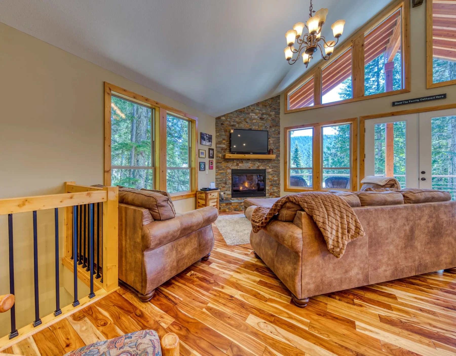 A living room with seating arranged around a fireplace and television.