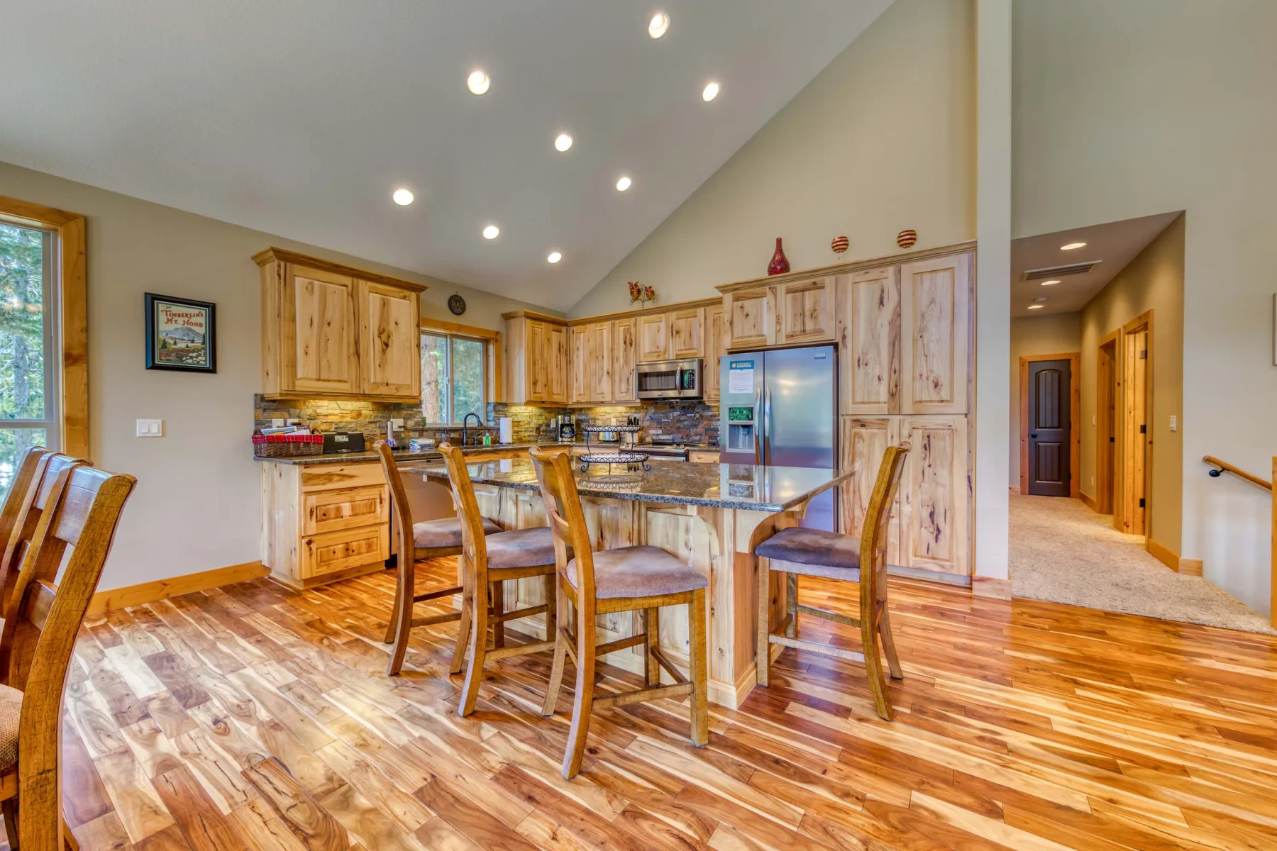 A spacious kitchen and dining area with wooden cabinets and a dining table.