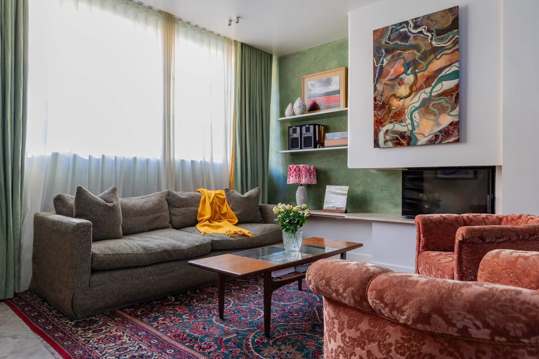 A living room with a gray sofa, coffee table, and fireplace.