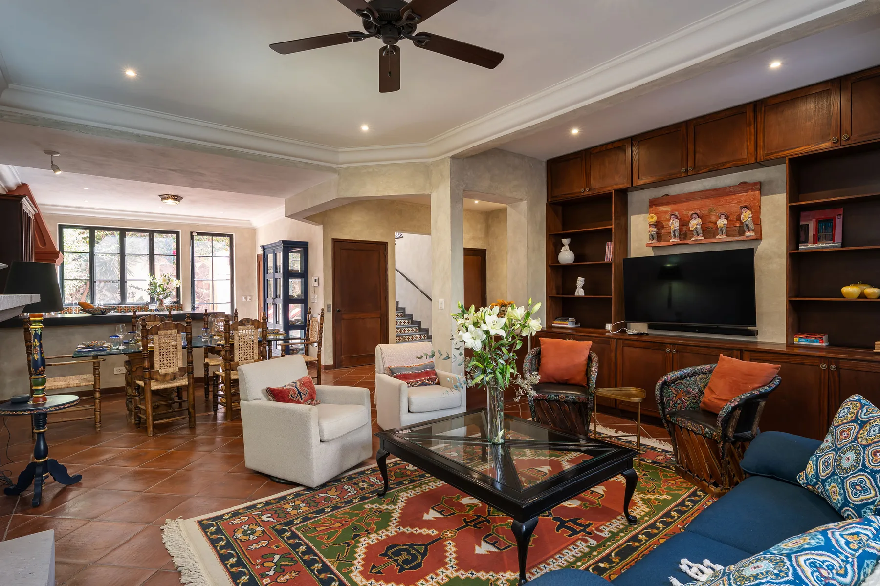 A living room with seating arranged around a glass coffee table.