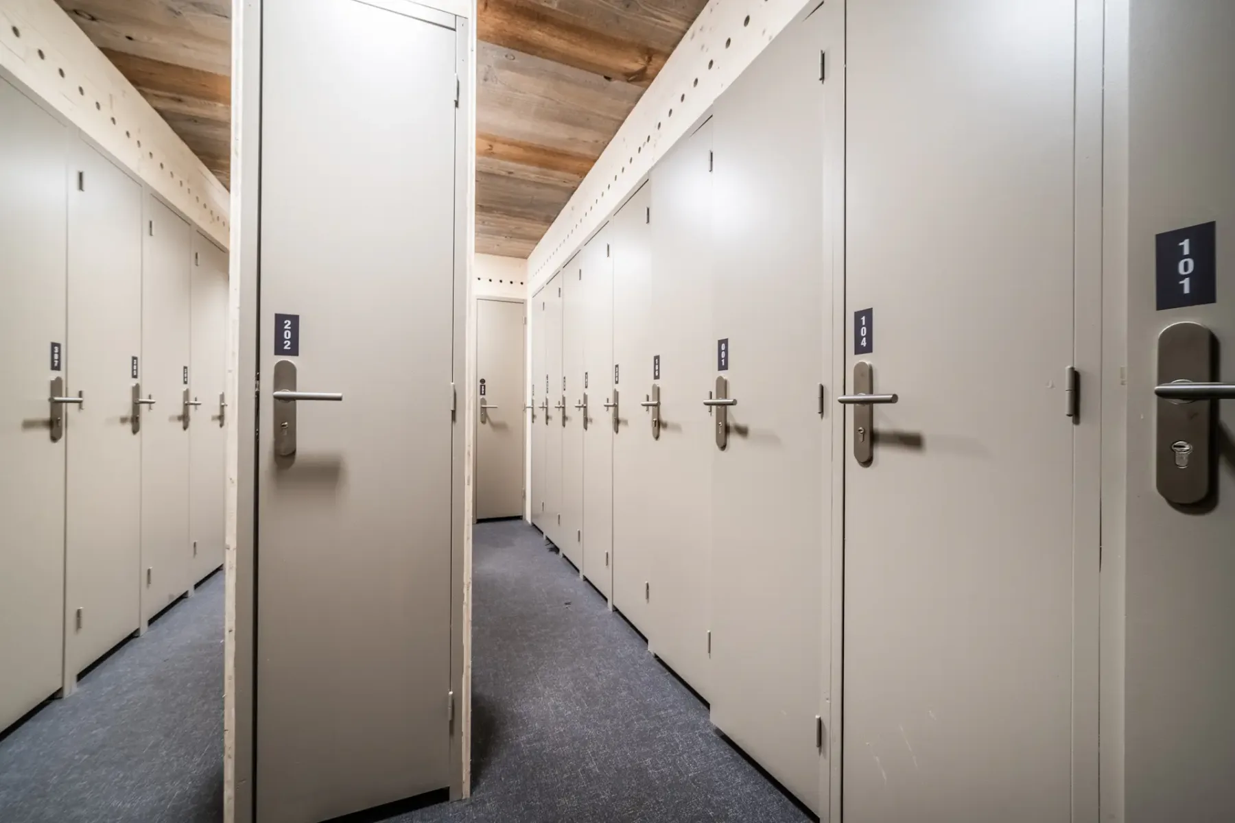 Zona común: Un pasillo con puertas blancas y cerraduras electrónicas.
