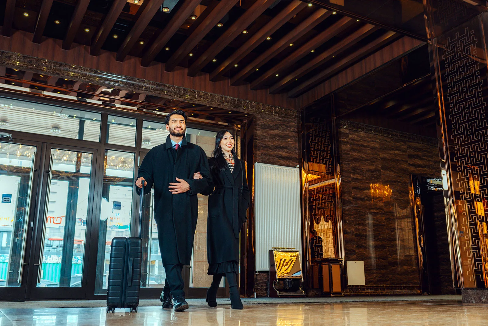 Representative hotel space: Hotel lobby with two people standing near the glass entrance.
