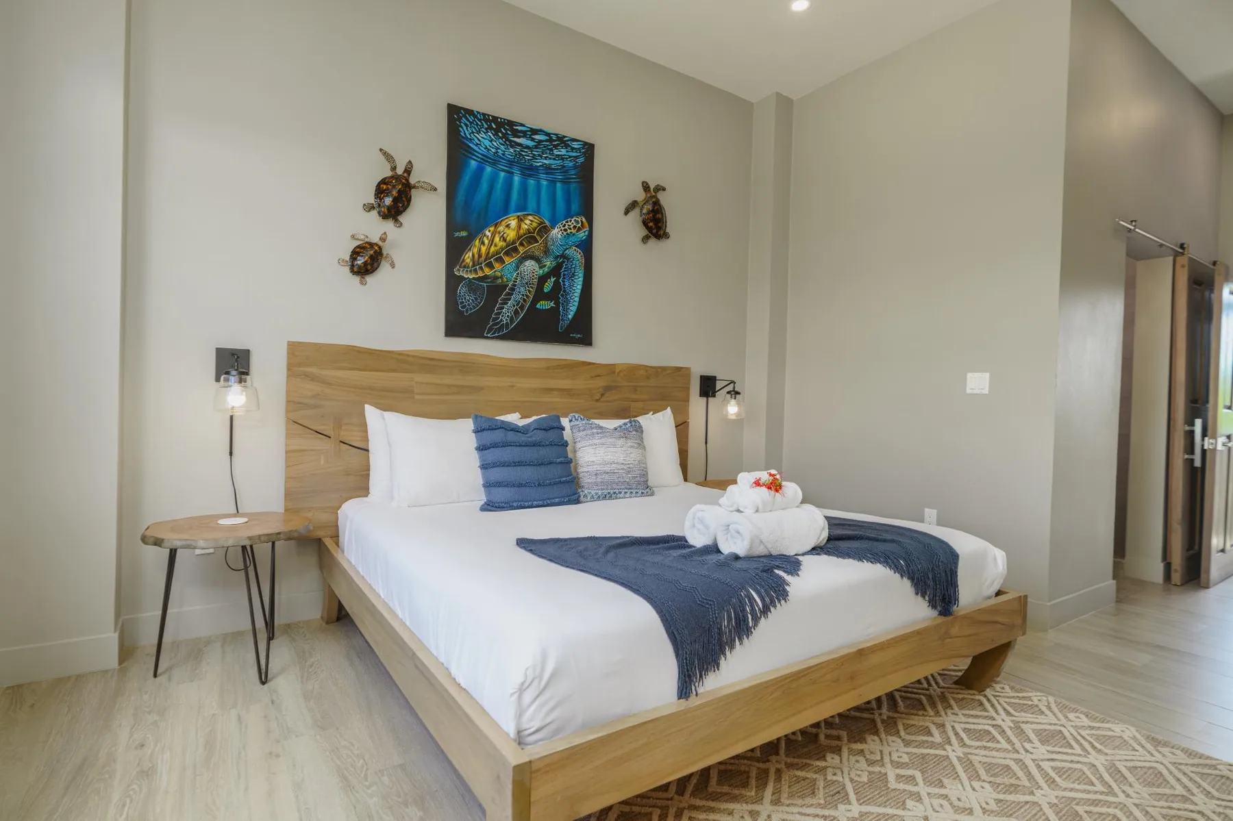 A bedroom with a neatly made bed and blue accents.