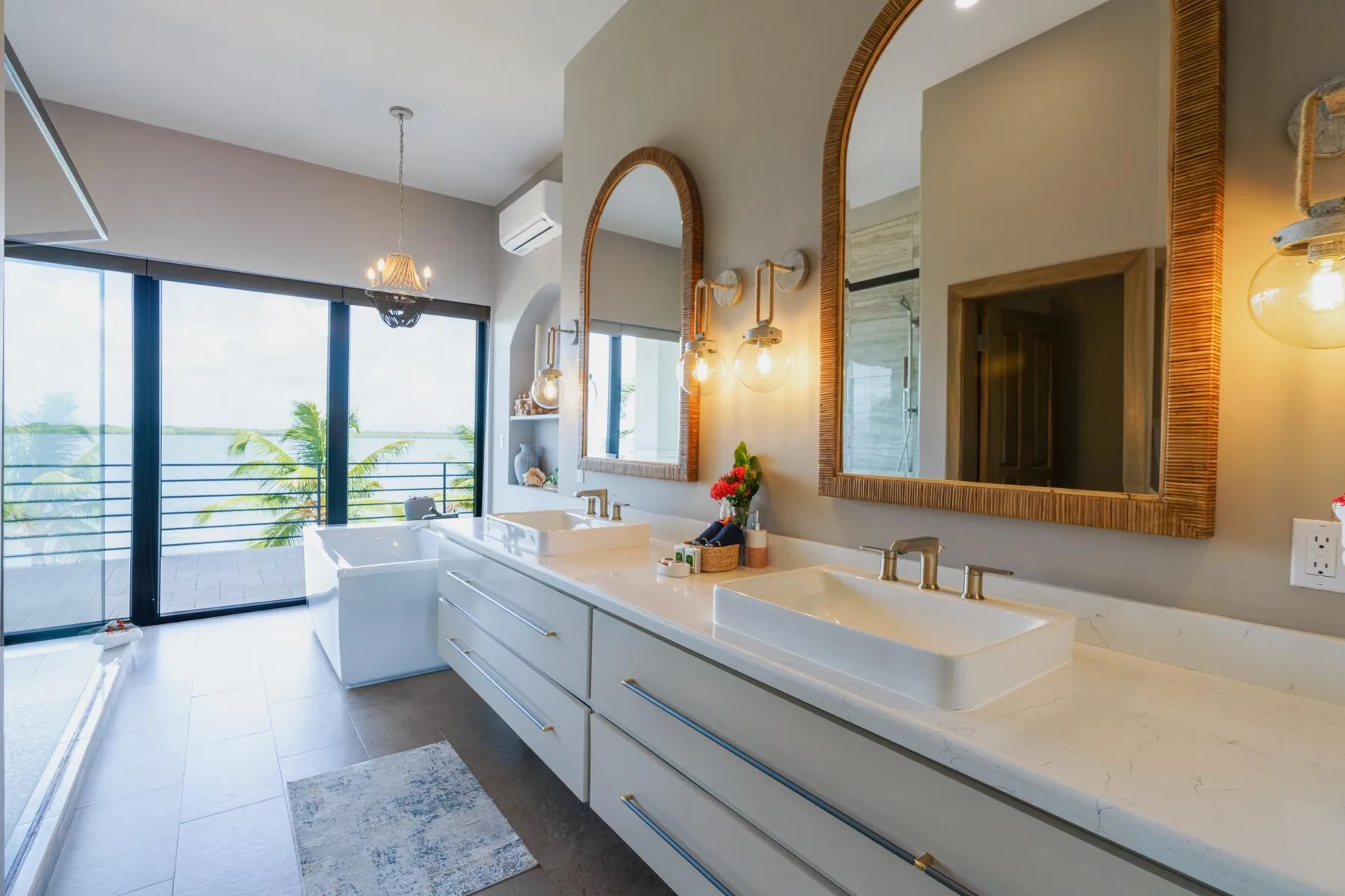 A bright bathroom with a long vanity, vessel sinks, and large mirrors.