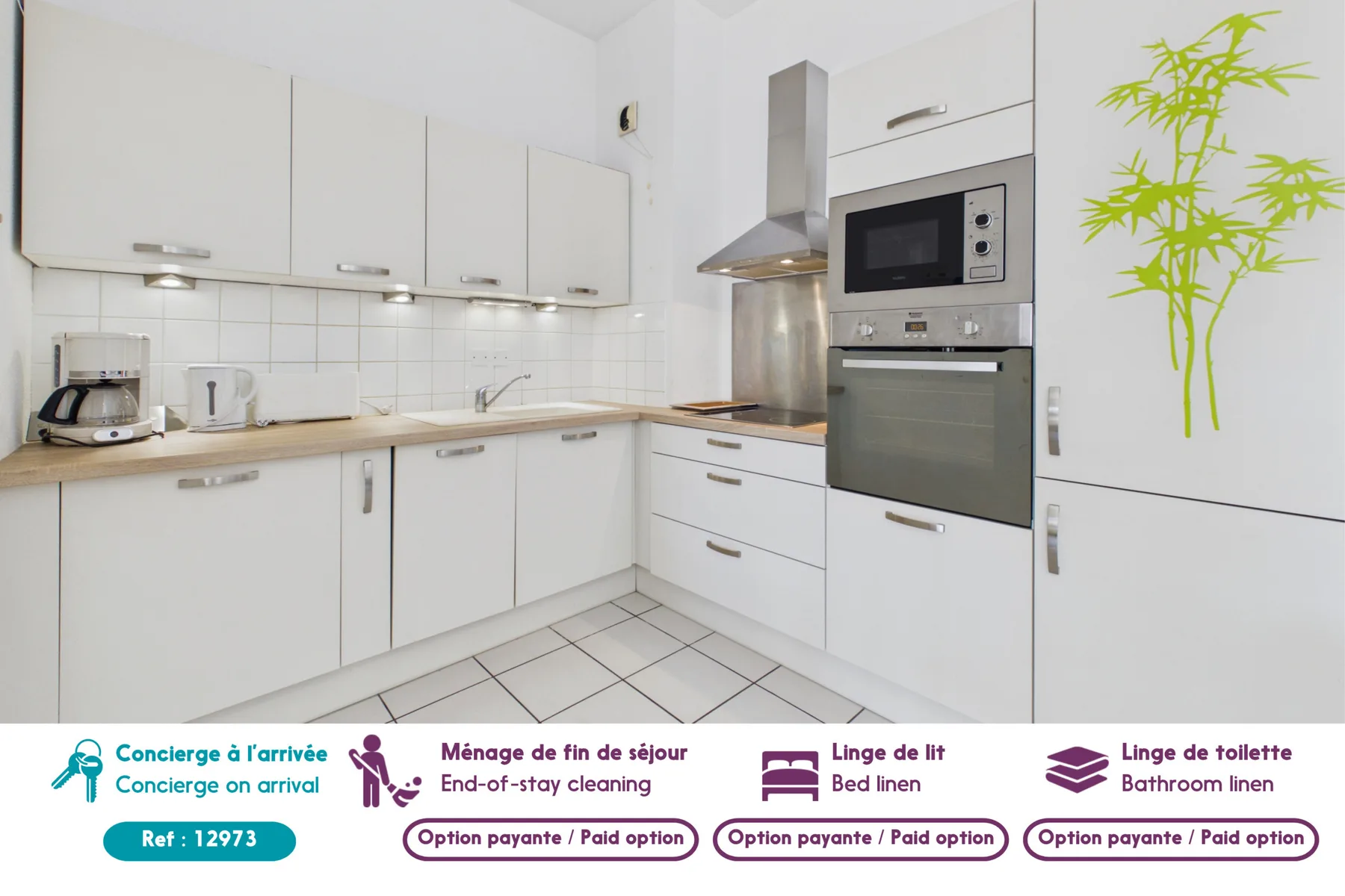 A bright white kitchen with a countertop, cabinets, and built-in appliances.