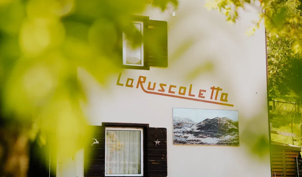 Representative hotel space: A building exterior with a sign and a framed landscape picture.