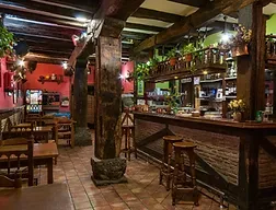 Representative hotel space: A rustic restaurant dining area with wooden tables beside a long bar.