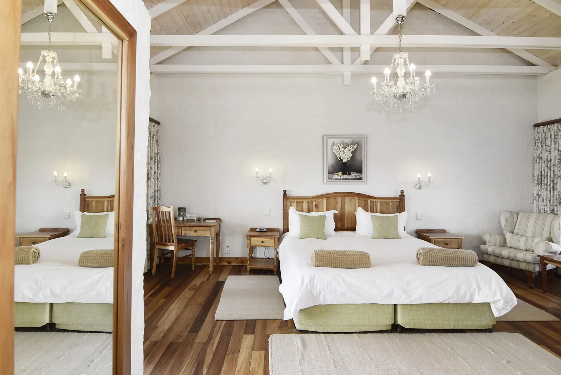 Representative hotel space: Bedroom with a large bed, bedside tables, and a seating area.