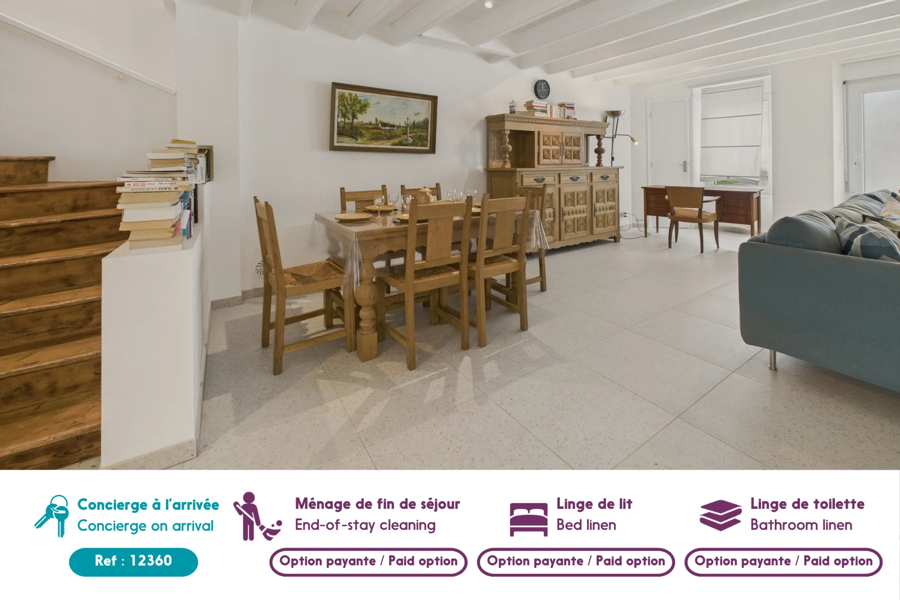 A dining and living area with a wooden table and seating.