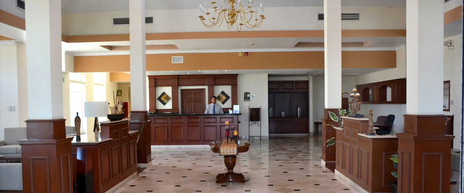 Representative hotel space: Hotel lobby with a reception desk and polished tiled floor.