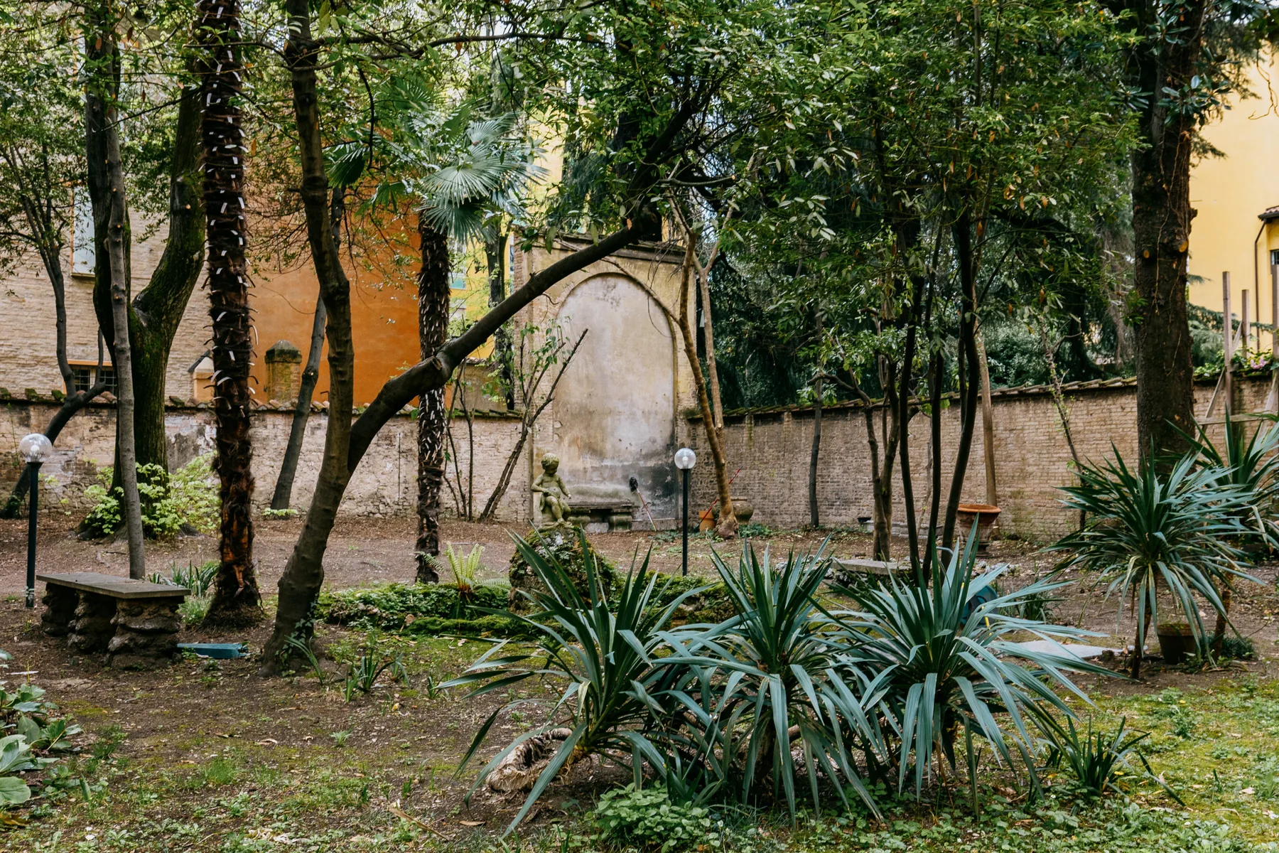 Shared amenity: A leafy garden courtyard with trees and low plants.