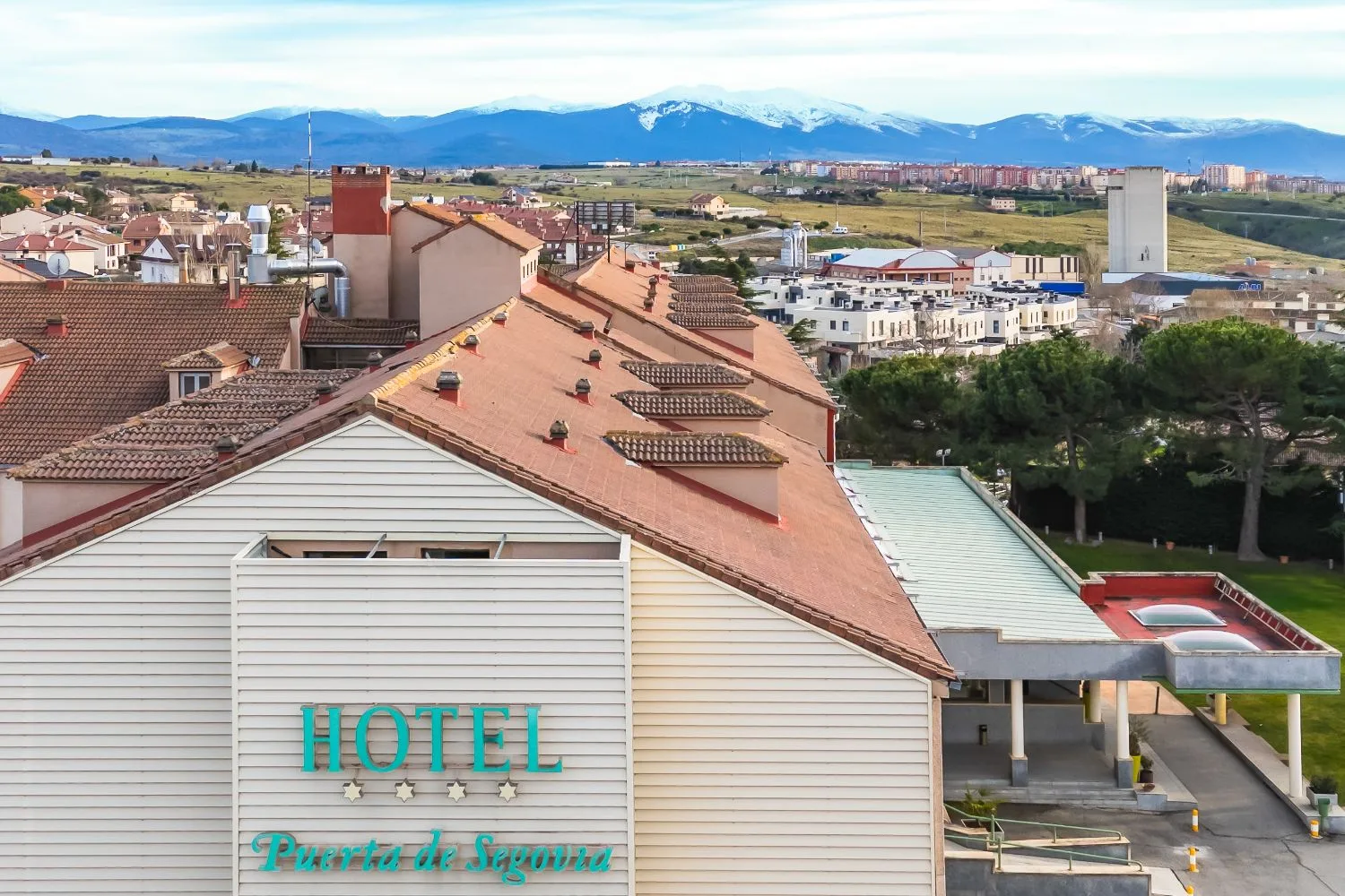 Representative hotel space: A hotel rooftop overlooks nearby buildings and a distant mountain range.