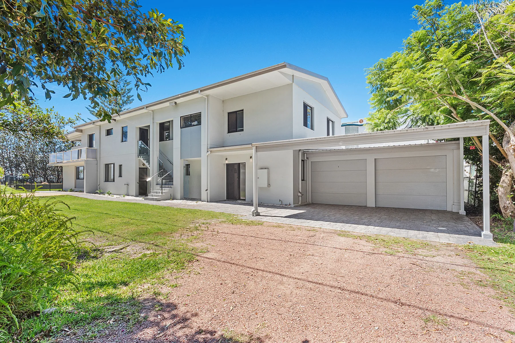 Shared amenity: A modern house with a long driveway and attached garage.