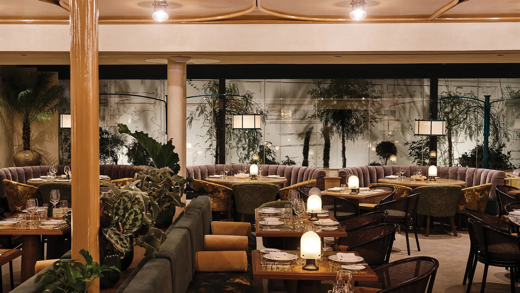 Representative hotel space: Hotel lounge with low seating, tables, and decorative plants.