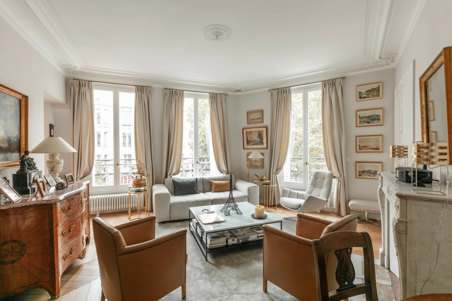 A bright living room with seating arranged around a coffee table.