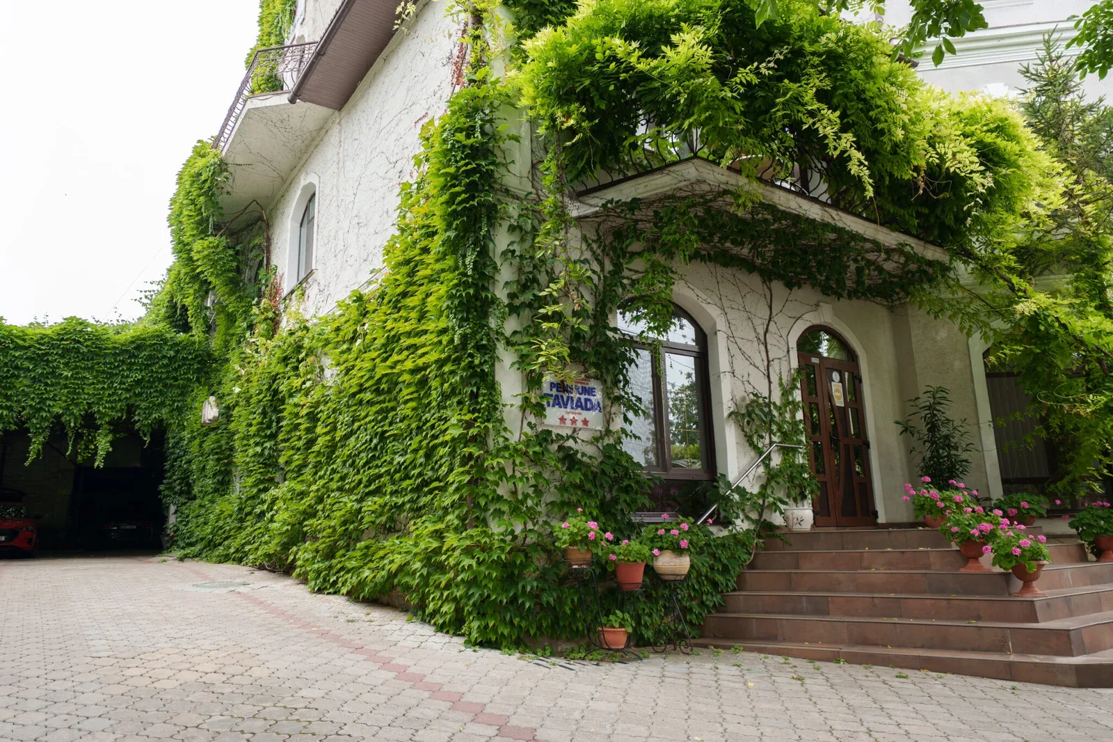 Representative hotel space: An ivy-covered building entrance opens onto a paved courtyard.
