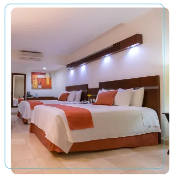 Representative hotel space: A hotel bedroom with neatly made beds and warm-toned linens.