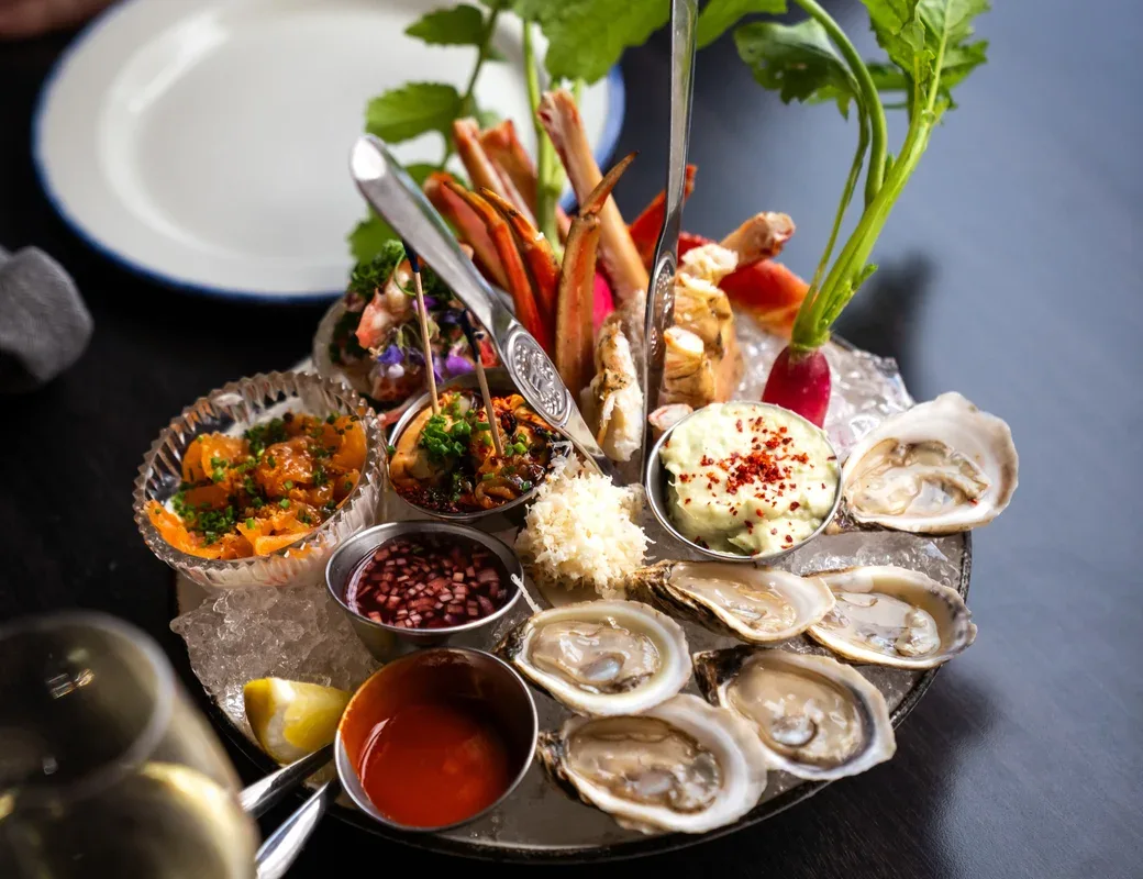 Representative hotel space: A seafood platter with oysters, sauces, and fresh greens.