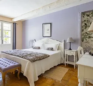 Representative hotel space: A bedroom with a neatly made bed and bedside table.