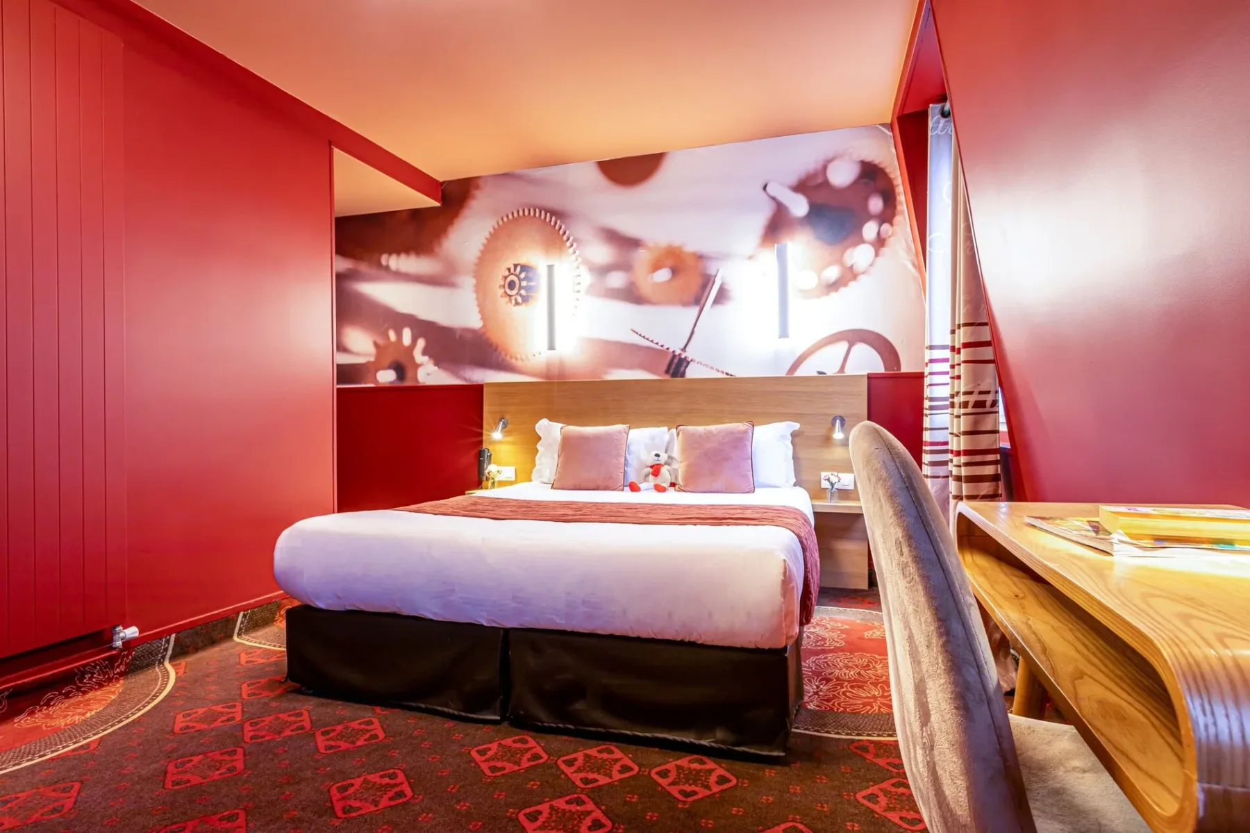 Representative hotel space: A hotel bedroom with a bed and a large mural behind the headboard.
