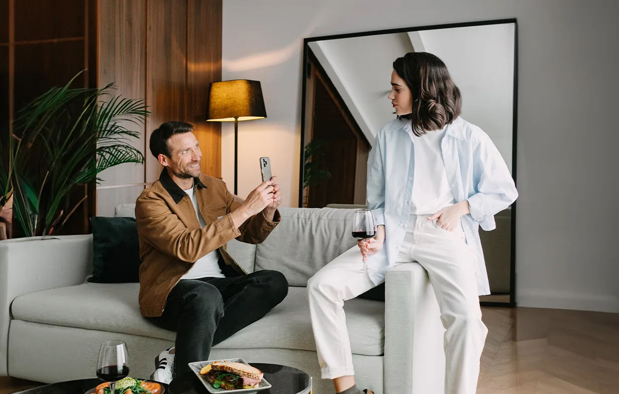 Representative hotel space: A lounge seating area with two people beside a low table.