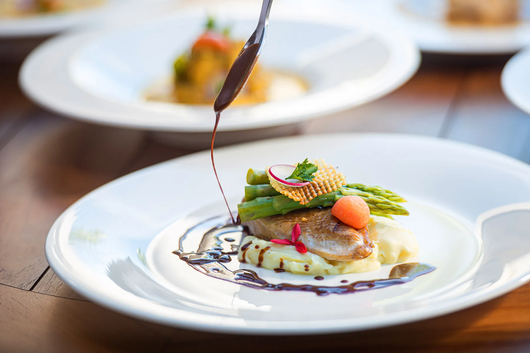 Representative hotel space: A plated meal garnished with asparagus and sauce