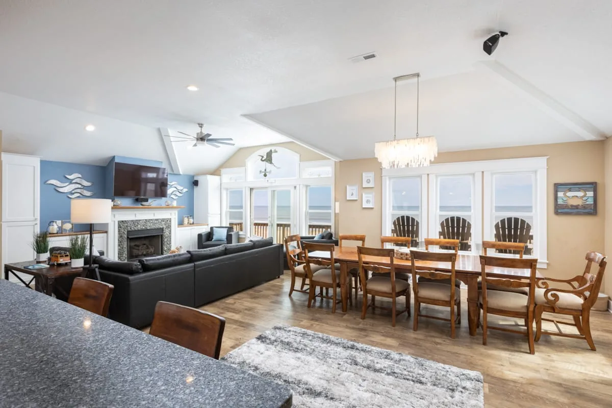 A living and dining area with a fireplace and a long dining table.