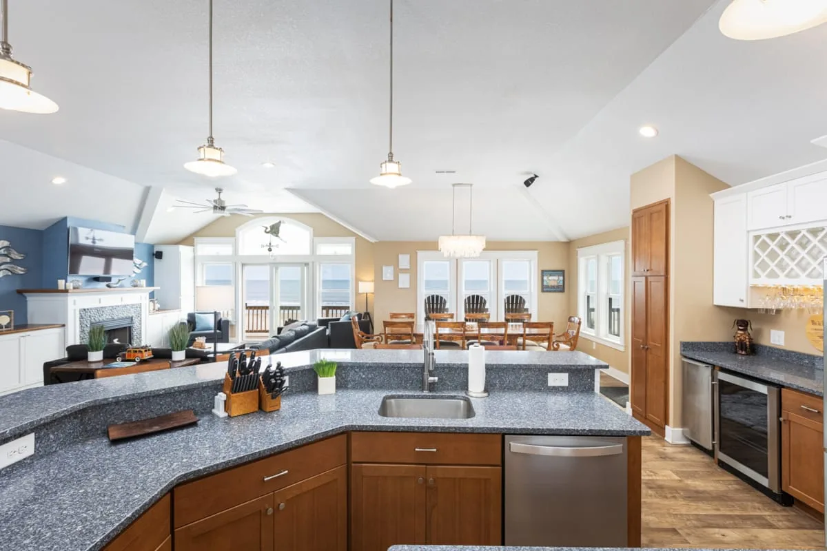 An open kitchen with a large island and a dining area beyond.