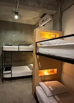 Representative hotel space: A compact sleeping room with bunk beds and warm built-in lighting.