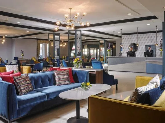 Representative hotel space: A hotel lobby lounge has colorful seating and a front desk.