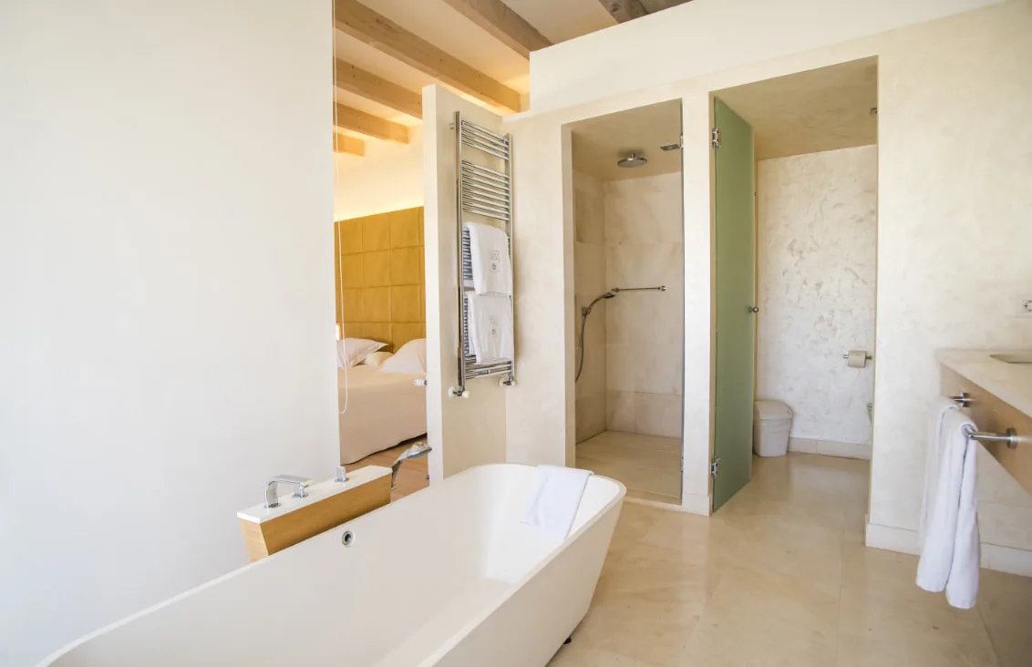Representative hotel space: A bright bathroom with a freestanding tub and an open shower area.