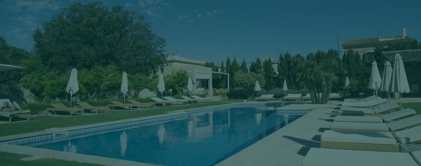 Representative hotel space: Outdoor swimming pool with lounge seating and umbrellas.