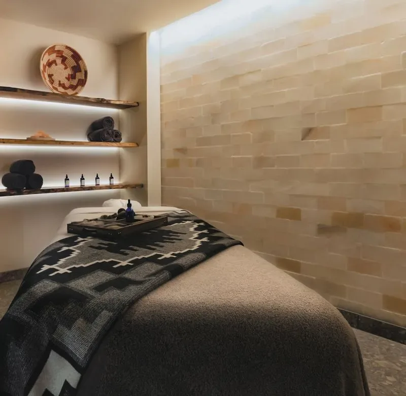 Representative hotel space: A treatment room with a cushioned table and shelves along the wall.