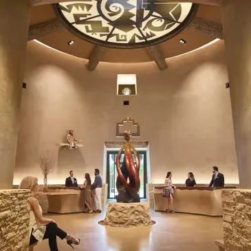 Representative hotel space: A spacious hotel lobby with a central sculpture and reception desks.