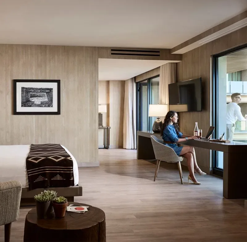 Representative hotel space: A hotel room with a bed, a desk, and floor-to-ceiling windows.