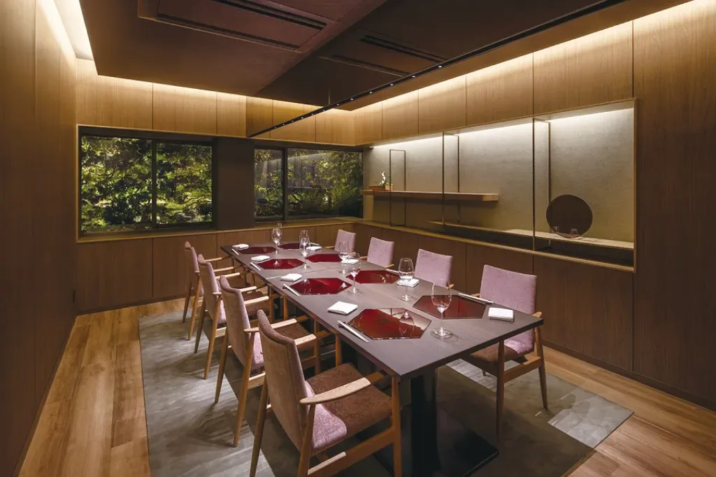 Espacio representativo del hotel: Un comedor privado con una mesa larga preparada con vajilla.