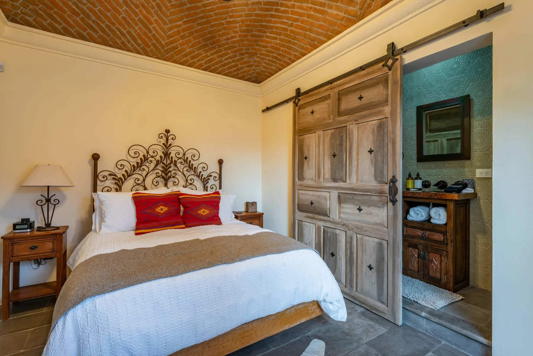 A bedroom with a bed beside a wooden sliding door.