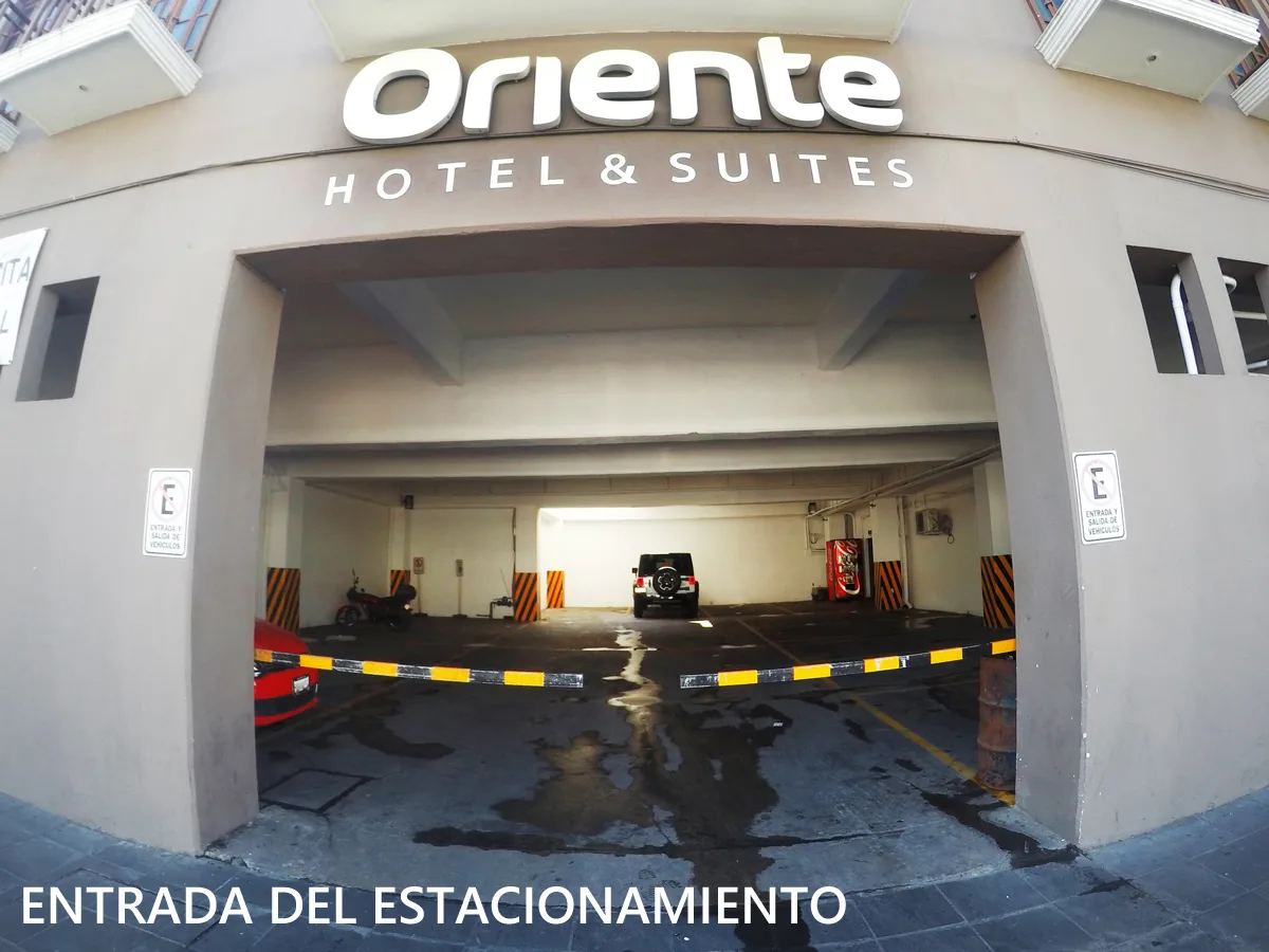 Representative hotel space: A hotel parking garage entrance with a vehicle barrier across the driveway.