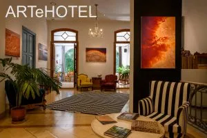 Representative hotel space: A hotel lobby with patterned armchairs and framed artwork.