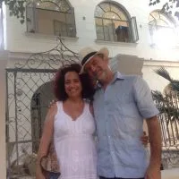 Representative hotel space: A couple poses in front of a building with arched windows and balconies.