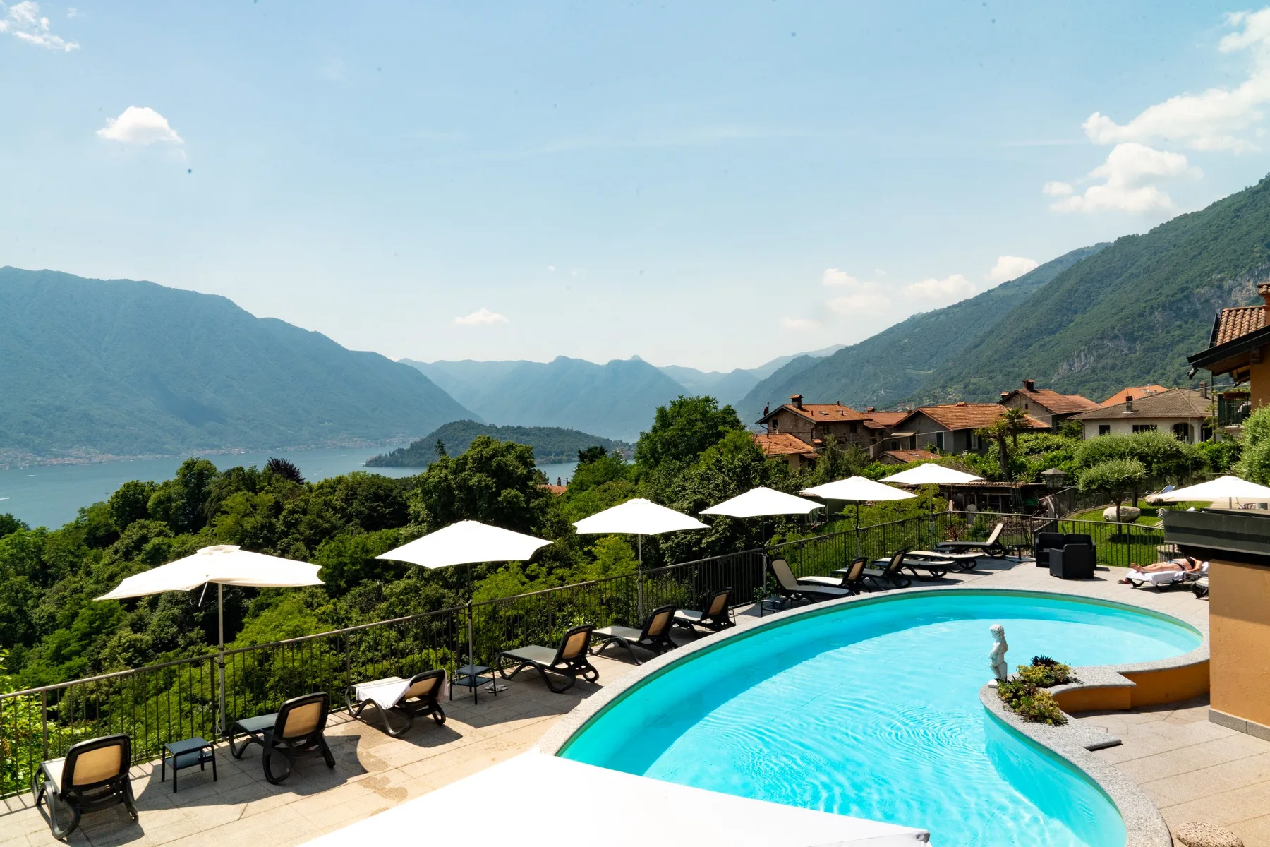 Representative hotel space: An outdoor pool terrace overlooks a lake and surrounding mountains.