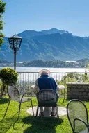 Representative hotel space: A lakeside patio with outdoor seating and a mountain view.