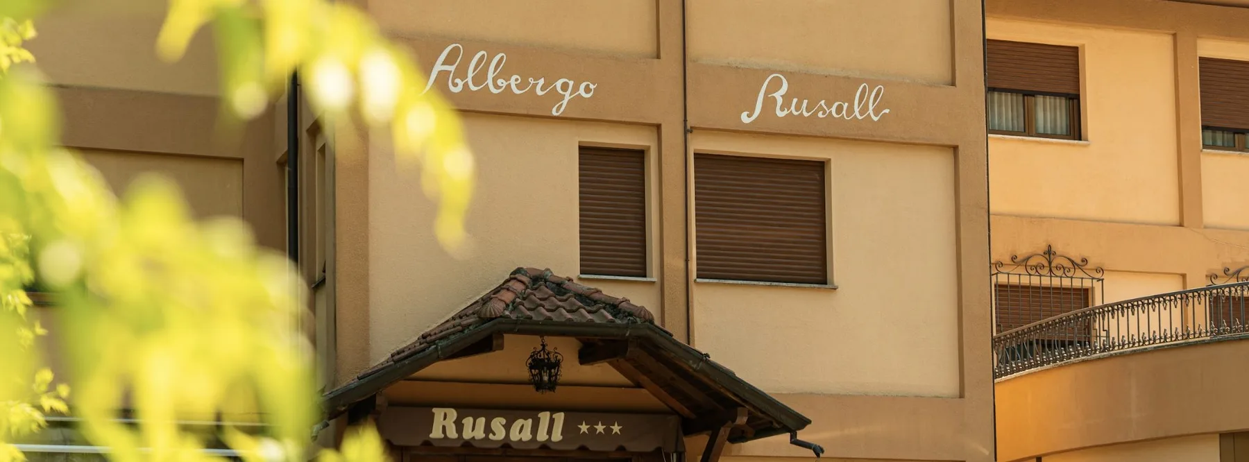 Representative hotel space: Hotel exterior with a covered entrance and balconies.