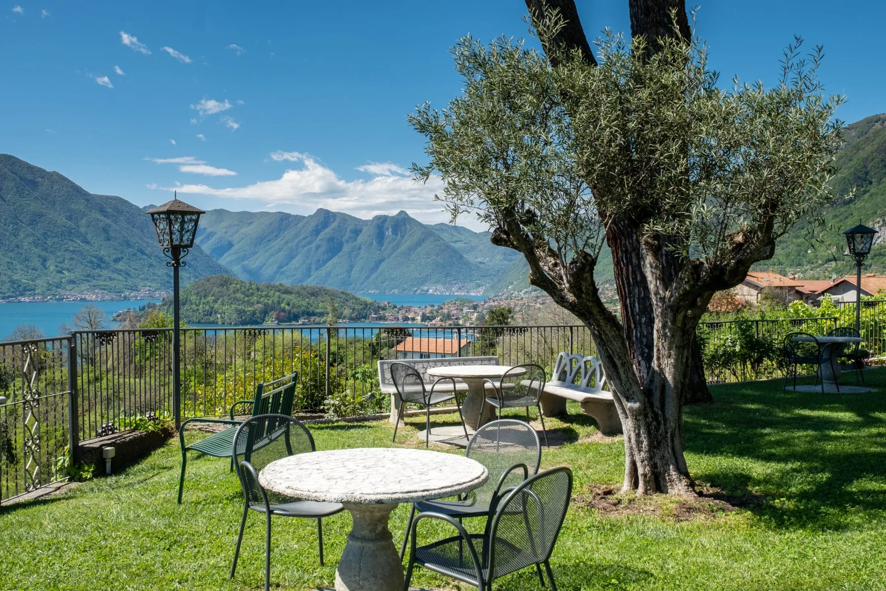 Representative hotel space: A garden seating area overlooks a lake and surrounding mountains.